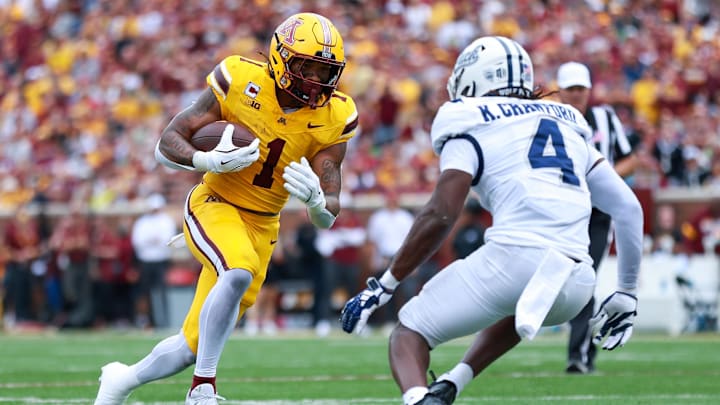 Sep 14, 2024; Minneapolis, Minnesota, USA; Minnesota Golden Gophers running back Darius Taylor (1) runs the ball as Nevada Wolf Pack safety Kitan Crawford (4) defends during the first half at Huntington Bank Stadium. Mandatory Credit: Matt Krohn-Imagn Images