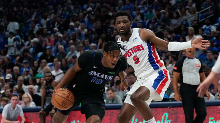 Apr 12, 2024; Dallas, Texas, USA; Dallas Mavericks forward Olivier-Maxence Prosper (18) drives to the basket past Detroit Pistons forward Chimezie Metu (5) during the first half at American Airlines Center. Mandatory Credit: Chris Jones-USA TODAY Sports