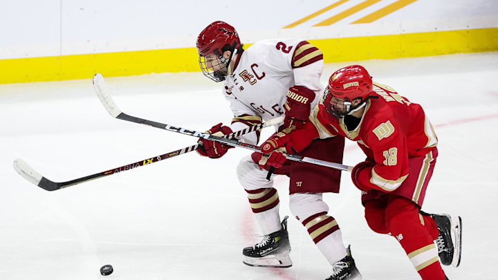 Apr 13, 2024; Saint Paul, Minnesota, USA; Boston College Eagles defenseman Eamon Powell (2) and Denver Pioneers forward Jared Wright (18) compete for the puck during the second period of the championship game of the 2024 Frozen Four college ice hockey tournament at Xcel Energy Center. Mandatory Credit: Matt Krohn-Imagn Images