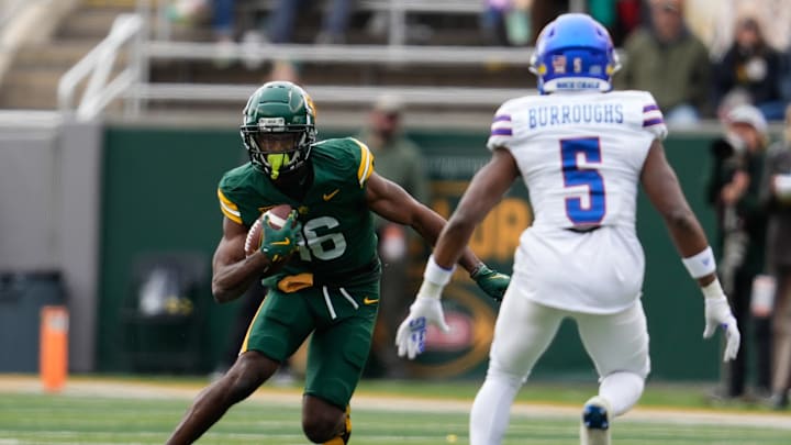 Former Baylor Bears wide receiver Hal Presley (16) runs after a catch against Kansas Jayhawks safety O.J. Burroughs (5) 