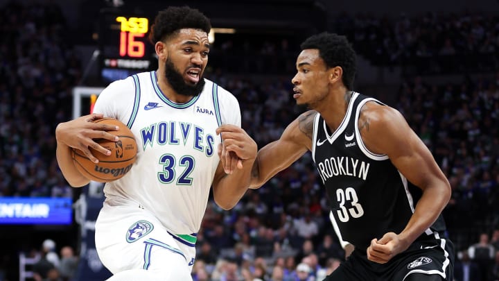 Feb 24, 2024; Minneapolis, Minnesota, USA; Minnesota Timberwolves center Karl-Anthony Towns (32) works around Brooklyn Nets center Nic Claxton (33) during the first half at Target Center. Mandatory Credit: Matt Krohn-USA TODAY Sports