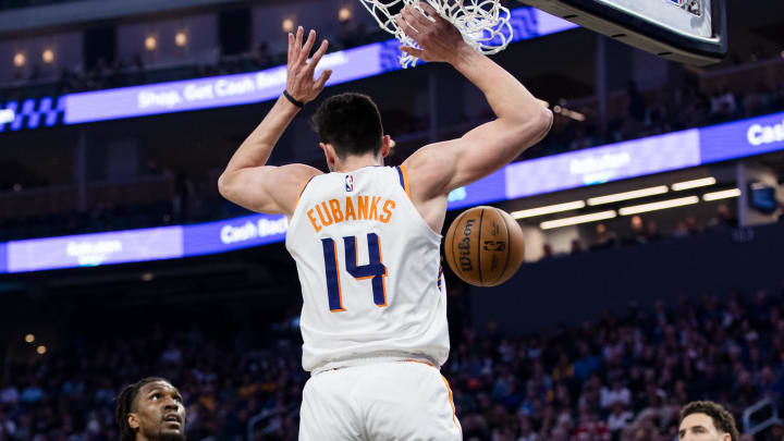 Feb 10, 2024; San Francisco, California, USA; Phoenix Suns center Drew Eubanks (14) dunks in front of Golden State Warriors center Kevon Looney (5) and guard Klay Thompson (11) during the first half at Chase Center. Mandatory Credit: John Hefti-USA TODAY Sports