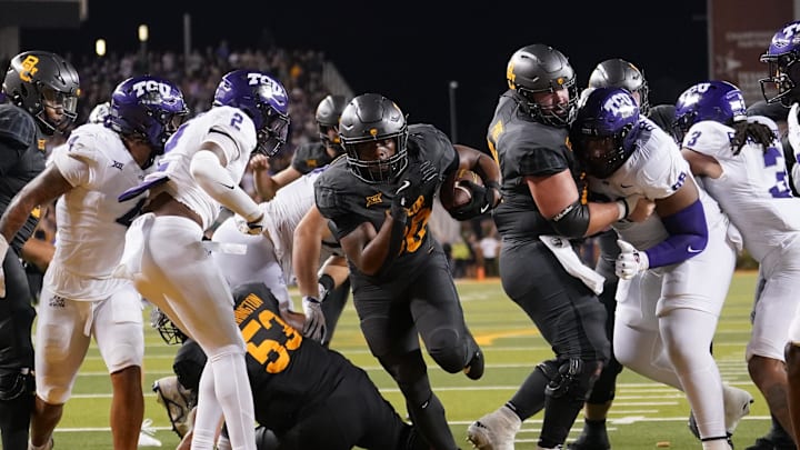 Nov 2, 2024; Waco, Texas, USA; Baylor Bears running back Bryson Washington (30) scores his fourth touchdown against the TCU Horned Frogs during the second half at McLane Stadium. Mandatory Credit: Chris Jones-Imagn Images