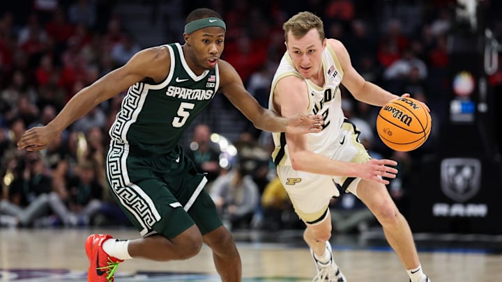 Mar 15, 2024; Minneapolis, MN, USA; Purdue Boilermakers guard Fletcher Loyer (2) works around Michigan State Spartans guard Tre Holloman (5) during the first half at Target Center. Mandatory Credit: Matt Krohn-Imagn Images