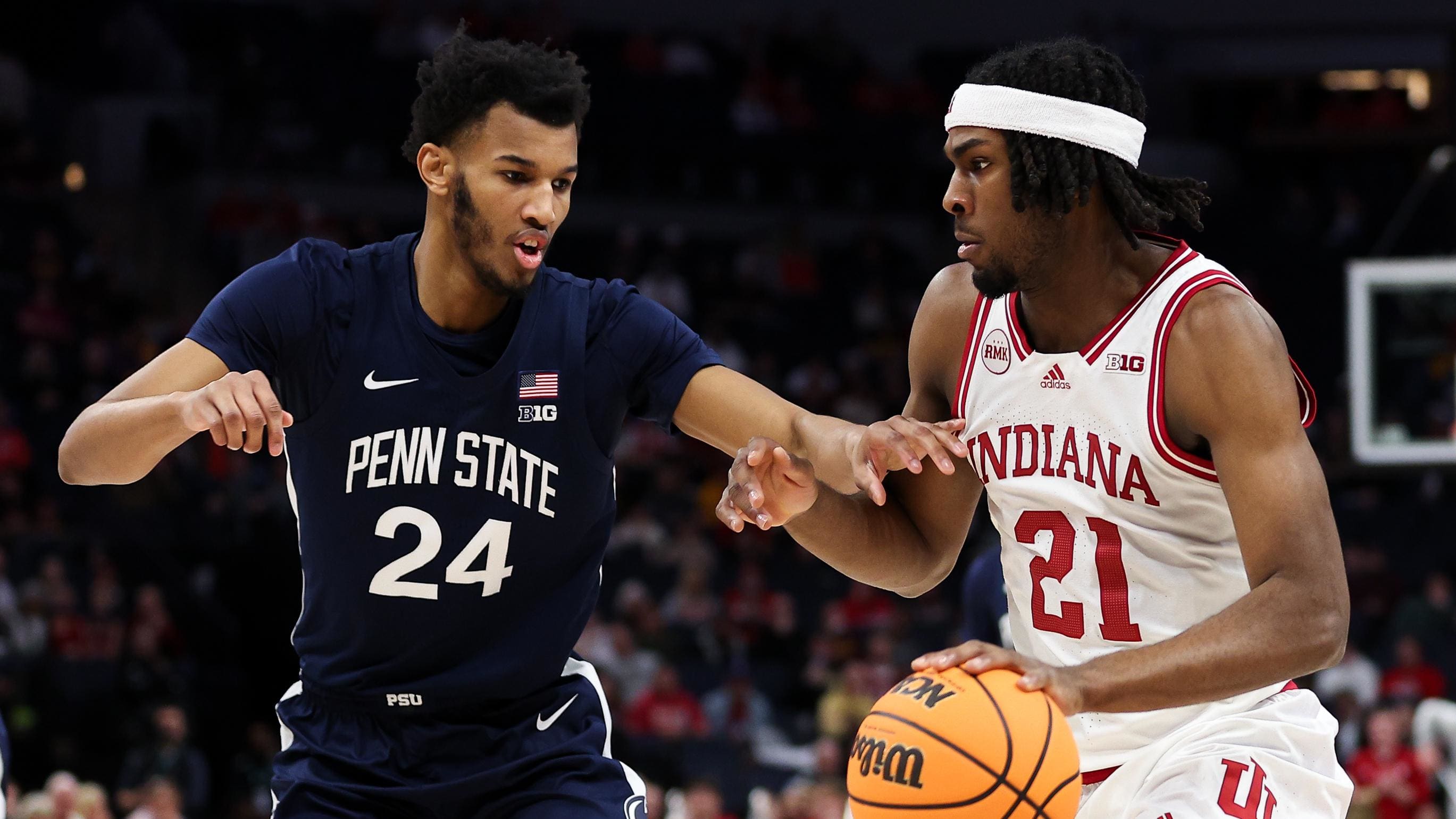 Indiana forward Mackenzie Mgbako (21) dribbles around a Penn State defender.