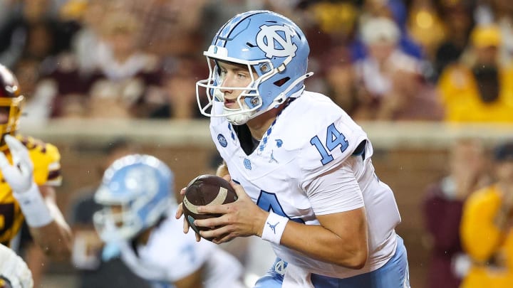 Aug 29, 2024; Minneapolis, Minnesota, USA; North Carolina Tar Heels quarterback Max Johnson (14) runs the ball against the Minnesota Golden Gophers during the first half at Huntington Bank Stadium. Mandatory Credit: Matt Krohn-USA TODAY Sports