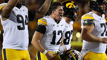 Sep 21, 2024; Minneapolis, Minnesota, USA; Iowa Hawkeyes quarterback Cade McNamara (12) celebrates quarterback Brendan Sullivans (1) touchdown against the Minnesota Golden Gophers during the second half at Huntington Bank Stadium. Mandatory Credit: Matt Krohn-Imagn Images