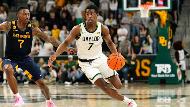 Baylor Bears guard VJ Edgecombe (7) drives to the basket ahead of West Virginia Mountaineers guard Javon Small (7)