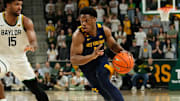 Feb 15, 2025; Waco, Texas, USA; West Virginia Mountaineers guard Joseph Yesufu (1) drives to the basket ahead of Baylor Bears forward Norchad Omier (15) during the first half at Paul and Alejandra Foster Pavilion. Mandatory Credit: Chris Jones-Imagn Images