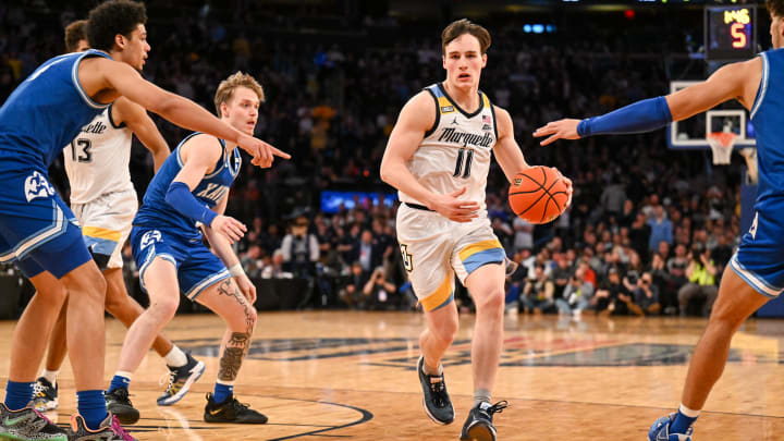 Mar 11, 2023; New York, NY, USA; Marquette Golden Eagles guard Tyler Kolek (11) runs with the ball past Xavier Musketeers guard Adam Kunkel (5) and Xavier Musketeers forward Cesare Edwards (4) at Madison Square Garden. Mandatory Credit: Mark Smith-USA TODAY Sports