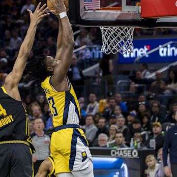 Mar 22, 2024; San Francisco, California, USA; Indiana Pacers forward Aaron Nesmith (23) shoots as Golden State Warriors guard Moses Moody (4) defends during the second half at Chase Center. Mandatory Credit: John Hefti-Imagn Images