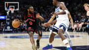 Apr 3, 2024; Minneapolis, Minnesota, USA; Toronto Raptors guard Javon Freeman-Liberty (0) works up court as Minnesota Timberwolves guard Anthony Edwards (5) defends during the third quarter at Target Center. Mandatory Credit: Matt Krohn-USA TODAY Sports