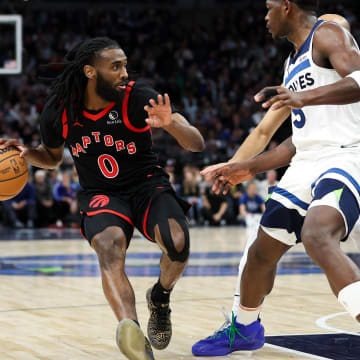 Apr 3, 2024; Minneapolis, Minnesota, USA; Toronto Raptors guard Javon Freeman-Liberty (0) works up court as Minnesota Timberwolves guard Anthony Edwards (5) defends during the third quarter at Target Center. Mandatory Credit: Matt Krohn-USA TODAY Sports