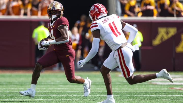 Sep 30, 2023; Minneapolis, Minnesota, USA; Minnesota Golden Gophers wide receiver Corey Crooms Jr. (4) runs after a catch while Louisiana-Lafayette Ragin Cajuns cornerback Caleb Anderson (11) defends during the third quarter at Huntington Bank Stadium. 