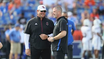 Florida head coach Billy Napier, right, and Mississippi State head coach Jeff Lebby chat Florida quarterback Tramell Jones Jr. (17) before an NCAA football game at Steve Spurrier Field at Ben Hill Griffin Stadium in Gainesville, FL on Saturday, October 18, 2025. [Alan Youngblood/Gainesville Sun]