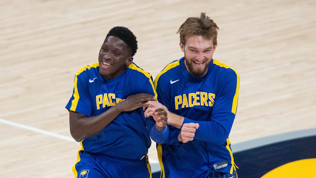 Dec 31, 2020; Indianapolis, Indiana, USA; Indiana Pacers forward Domantas Sabonis (11) and guard Victor Oladipo (4) share a laugh during warm ups before the game against the Cleveland Cavaliers in the first quarter at Bankers Life Fieldhouse. Mandatory Credit: Trevor Ruszkowski-Imagn Images