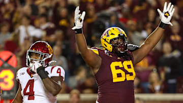 Oct 5, 2024; Minneapolis, Minnesota, USA; Minnesota Golden Gophers offensive lineman Aireontae Ersery (69) celebrates quarterback Max Brosmer's (16) touchdown against the USC Trojans during the first half at Huntington Bank Stadium. Mandatory Credit: Matt Krohn-Imagn Images