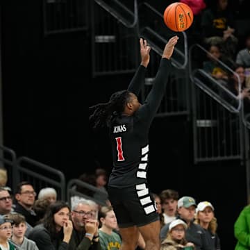 Jan 7, 2025; Waco, Texas, USA;  Cincinnati Bearcats guard Day Day Thomas (1) scores a three-point basket against Baylor Bears guard VJ Edgecombe (7) during the first half at Paul and Alejandra Foster Pavilion. Mandatory Credit: Chris Jones-Imagn Images