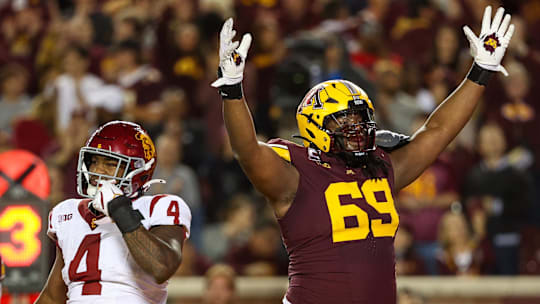 Oct 5, 2024; Minneapolis, Minnesota, USA; Minnesota Golden Gophers offensive lineman Aireontae Ersery (69) celebrates quarterback Max Brosmer's (16) touchdown against the USC Trojans during the first half at Huntington Bank Stadium. Mandatory Credit: Matt Krohn-Imagn Images