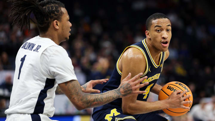 Mar 13, 2024; Minneapolis, MN, USA; Michigan Wolverines guard Nimari Burnett (4) works around Penn State Nittany Lions guard Ace Baldwin Jr. (1) during the first half at Target Center. Mandatory Credit: Matt Krohn-USA TODAY Sports