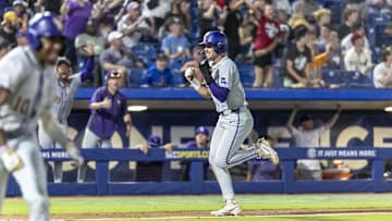 May 23, 2024; Hoover, AL, USA; LSU Tigers outfielder Jake Brown (18) scores the go ahead run on a single by LSU Tigers shortstop Michael Braswell (10) for an 11-10 lead over South Carolina Gamecocks during the SEC Baseball Tournament at Hoover Metropolitan Stadium. Mandatory Credit: Vasha Hunt-Imagn Images