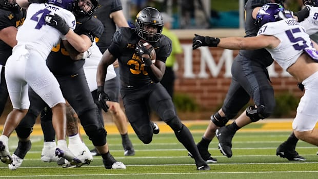 Baylor running back Bryson Washington runs the ball as Johnny Hodges tries to tackle him against TCU.