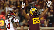 Oct 5, 2024; Minneapolis, Minnesota, USA; Minnesota Golden Gophers offensive lineman Aireontae Ersery (69) celebrates quarterback Max Brosmer's (16) touchdown against the USC Trojans during the first half at Huntington Bank Stadium. Mandatory Credit: Matt Krohn-Imagn Images