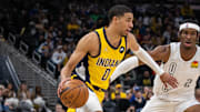 Indiana Pacers guard Tyrese Haliburton dribbles the ball while Oklahoma City Thunder guard Shai Gilgeous-Alexander defends in the second half at Gainbridge Fieldhouse. 