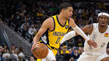 Indiana Pacers guard Tyrese Haliburton dribbles the ball while Oklahoma City Thunder guard Shai Gilgeous-Alexander defends in the second half at Gainbridge Fieldhouse. 