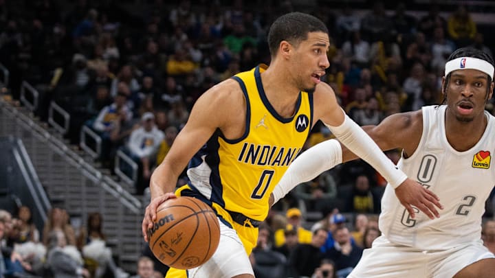 Indiana Pacers guard Tyrese Haliburton dribbles the ball while Oklahoma City Thunder guard Shai Gilgeous-Alexander defends in the second half at Gainbridge Fieldhouse. 