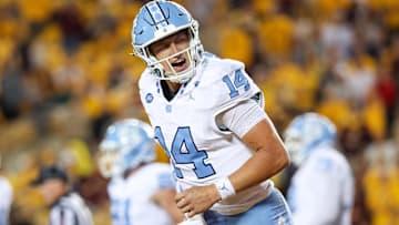 Aug 29, 2024; Minneapolis, Minnesota, USA; North Carolina Tar Heels quarterback Max Johnson (14) celebrates his rushing touchdown against the Minnesota Golden Gophers.