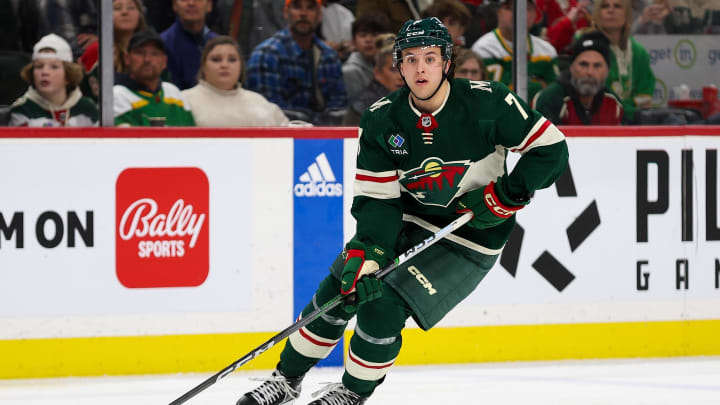 Feb 27, 2024; Saint Paul, Minnesota, USA; Minnesota Wild defenseman Brock Faber (7) skates with the puck during the second period against the Carolina Hurricanes at Xcel Energy Center. Mandatory Credit: Matt Krohn-USA TODAY Sports