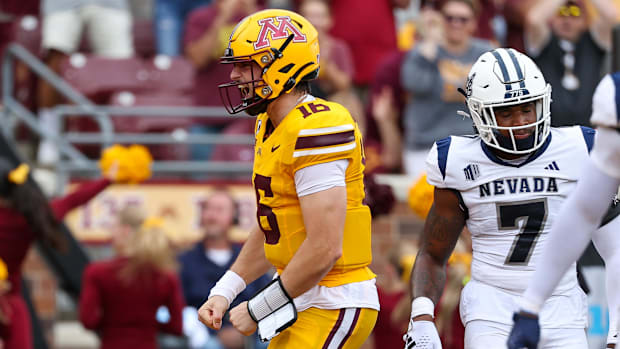 Minnesota Golden Gophers quarterback Max Brosmer (16) celebrates running back Darius Taylor's (1) touchdown against the Nevad