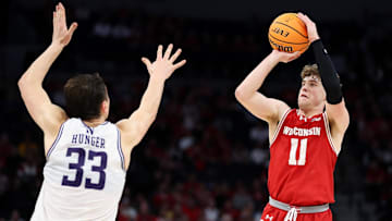 Mar 15, 2024; Minneapolis, MN, USA; Wisconsin Badgers guard Max Klesmit (11) shoots as Northwestern Wildcats forward Luke Hunger (33) defends during the second half at Target Center. Mandatory Credit: Matt Krohn-Imagn Images