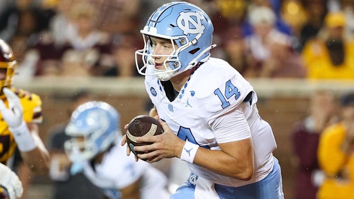 Aug 29, 2024; Minneapolis, Minnesota, USA; North Carolina Tar Heels quarterback Max Johnson (14) runs the ball against the Minnesota Golden Gophers during the first half at Huntington Bank Stadium. Mandatory Credit: Matt Krohn-Imagn Images