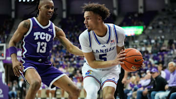 Jan 22, 2025; Fort Worth, Texas, USA;  Kansas Jayhawks guard Zeke Mayo (5) controls the ball as TCU Horned Frogs forward Trazarien White (13) defends during the second half at Ed and Rae Schollmaier Arena. Mandatory Credit: Chris Jones-Imagn Images