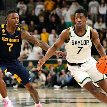 Feb 15, 2025; Waco, Texas, USA; Baylor Bears guard VJ Edgecombe (7) drives to the basket ahead of West Virginia Mountaineers guard Javon Small (7) during the second half at Paul and Alejandra Foster Pavilion. Mandatory Credit: Chris Jones-Imagn Images