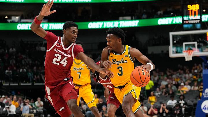 Nov 9, 2024; Dallas, Texas, USA;  Baylor Bears guard Jeremy Roach (3) drives to the basket against Arkansas Razorbacks forward Billy Richmond III (24) during the first half at American Airlines Center. Mandatory Credit: Chris Jones-Imagn Images