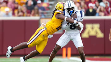 Sep 14, 2024; Minneapolis, Minnesota, USA; Nevada Wolf Pack wide receiver Cortez Braham Jr. (8) catches a pass as Minnesota Golden Gophers defensive back Darius Green (12) defends during the first half at Huntington Bank Stadium. Mandatory Credit: Matt Krohn-Imagn Images