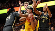 Minnesota's Dawson Garcia controls the ball as Purdue's Gicarri Harris, Caleb Furst and Trey Kaufman-Renn defend