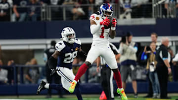Nov 28, 2024; Arlington, Texas, USA;  New York Giants wide receiver Malik Nabers (1) catches a pass as Dallas Cowboys safety Malik Hooker (28) gives chase during the first half at AT& T Stadium.  