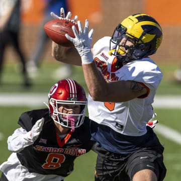 Jan 30, 2024; Mobile, AL, USA; National tight end Aj Barner of Michigan (89) grabs a pass with National defensive back Cole Bishop of Utah (8) pursuing during practice for the National team at Hancock Whitney Stadium. Mandatory Credit: Vasha Hunt-USA TODAY Sports