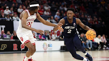 Penn State Nittany Lions guard D'Marco Dunn (2) dribbles around Indiana Hoosiers forward Mackenzie Mgbako (21) during the second half of a Big Ten Tournament game at Target Center in March 2024.  Both players are still contributing to their respective teams.