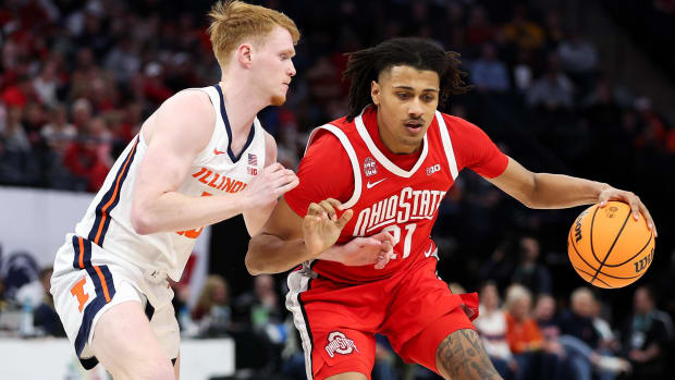 Basketball player backs down defender.