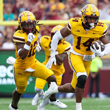 Sep 14, 2024; Minneapolis, Minnesota, USA; Minnesota Golden Gophers defensive back Kerry Brown (14) runs the ball after intercepting a pass against the Nevada Wolf Pack during the first half at Huntington Bank Stadium. Mandatory Credit: Matt Krohn-Imagn Images