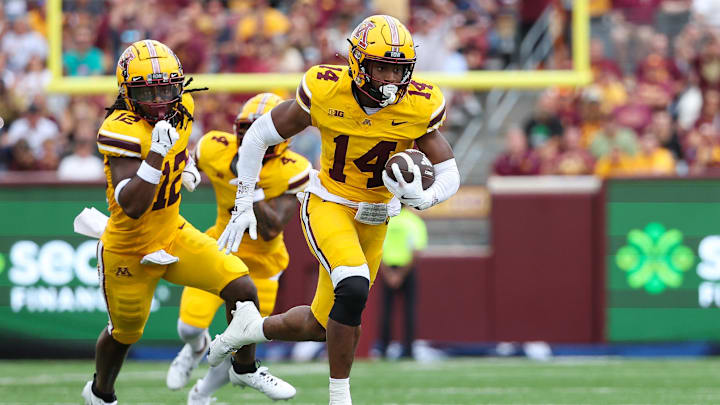 Sep 14, 2024; Minneapolis, Minnesota, USA; Minnesota Golden Gophers defensive back Kerry Brown (14) runs the ball after intercepting a pass against the Nevada Wolf Pack during the first half at Huntington Bank Stadium. Mandatory Credit: Matt Krohn-Imagn Images