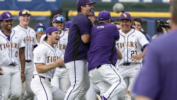 May 25, 2024; Hoover, AL, USA; LSU Tigers players cheer as their head coach Jay Johnson returns to the field after his ejection to celebrates with them postgame following a 12-11 tenth inning walkoff win over the South Carolina Gamecocks during the SEC Baseball Tournament at Hoover Metropolitan Stadium. Mandatory Credit: Vasha Hunt-Imagn Images