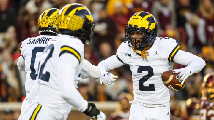 Oct 7, 2023; Minneapolis, Minnesota, USA; Michigan Wolverines defensive back Will Johnson (2) celebrates after returning an interception for a touchdown against the Minnesota Golden Gophers during the first quarter at Huntington Bank Stadium. Mandatory Credit: Matt Krohn-USA TODAY Sports