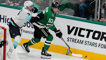 Oct 13, 2024; Dallas, Texas, USA;  Dallas Stars center Wyatt Johnston (53) controls the puck as Seattle Kraken defenseman Will Borgen (3) defends during the third period at American Airlines Center. Mandatory Credit: Chris Jones-Imagn Images