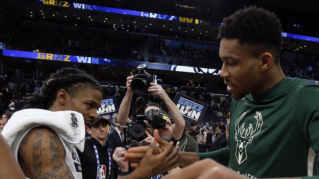 Dec 15, 2022; Memphis, Tennessee, USA; Memphis Grizzlies guard Ja Morant (left) and Milwaukee Bucks forward Giannis Antetokounmpo (34) shake hands after the game at FedExForum. Mandatory Credit: Petre Thomas-Imagn Images
